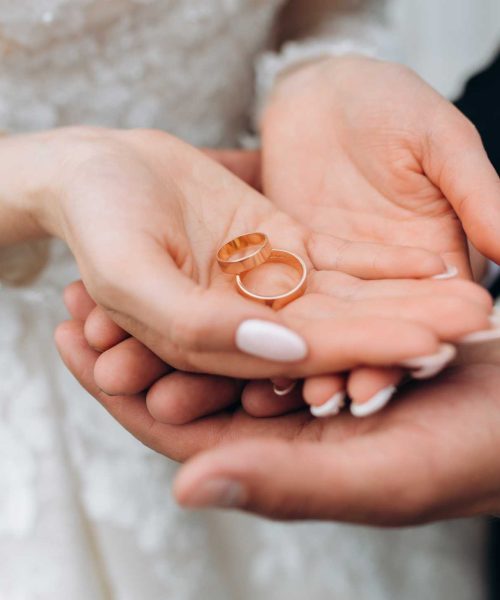 groom-holds-bride-s-hands-where-are-two-wedding-rings (2)
